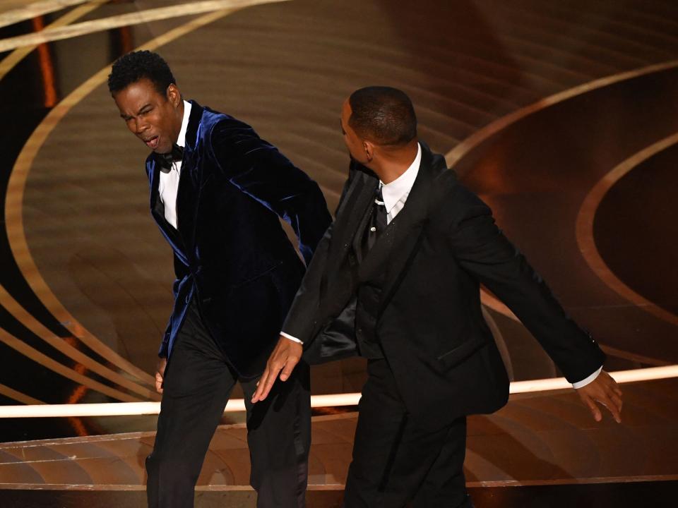 US actor Will Smith (R) slaps US actor Chris Rock onstage during the 94th Oscars at the Dolby Theatre in Hollywood, California on March 27, 2022.