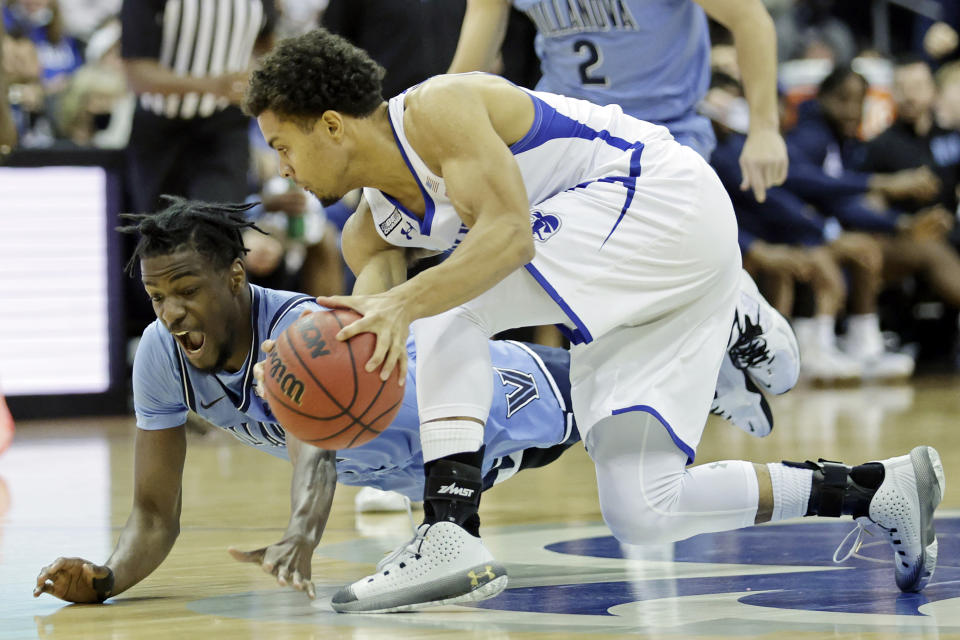 Villanova guard Bryan Antoine grabs a loose ball in front of Villanova forward Brandon Slater during the first half of an NCAA college basketball game Saturday, Jan. 1, 2022, in Newark, N.J. (AP Photo/Adam Hunger)