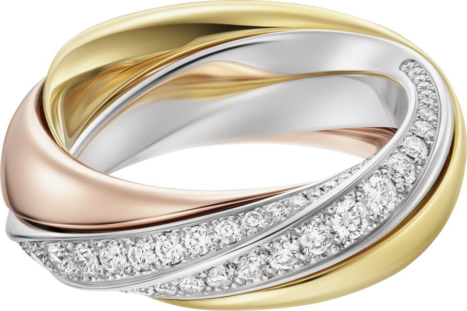 This Cartier Trinity design nods to a Japanese puzzle of interlocking pieces and reveals a pavé side when its three rings are arranged one way and a smooth band of blending metal in another.