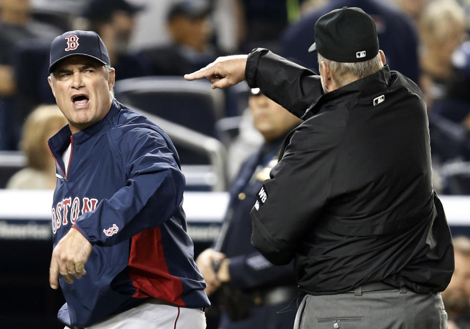 First base umpire Bob Davidson tosses out Boston Red Sox manager John Farrell who objected to MLB's ruling of a an overturned fourth-inning force out at first base in a baseball game against the New York Yankees at Yankee Stadium in New York, Sunday, April 13, 2014. The Yankees Brian McCann scored on the play. (AP Photo/Kathy Willens)