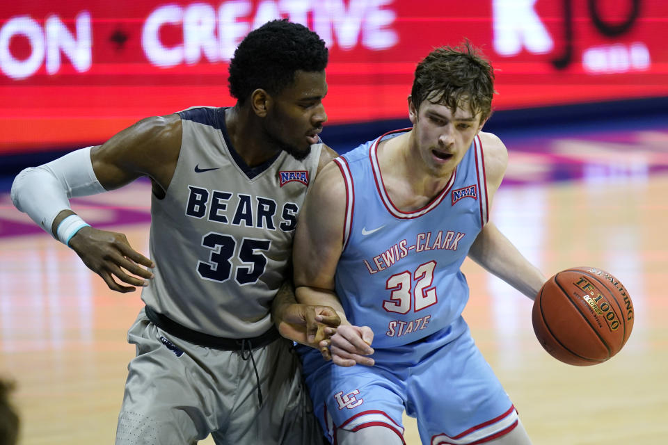 Shawnee State forward EJ Onu (35) defends against Lewis-Clark State forward Trystan Bradley (32) during the first half of final in the NAIA men's college basketball tournament in Kansas City, Mo., Tuesday, March 23, 2021. (AP Photo/Orlin Wagner)