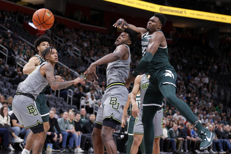 Michigan State center Mady Sissoko, right, and Baylor center Yves Missi, center, and Baylor forward Jalen Bridges, left, vie for a rebound during the first half of an NCAA college basketball game, Saturday, Dec. 16, 2023, in Detroit. (AP Photo/Al Goldis)