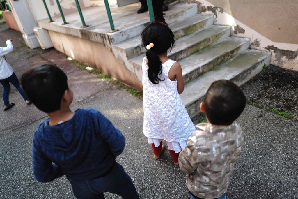 Children play outside a building as Afghan refugee families are evacuated from Kabul (AFP via Getty Images)