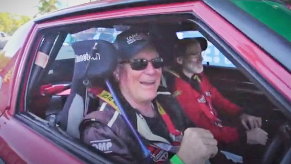 Shane Navin (pictured left) with Glenn Evans (pictured right) smiling in their Mazda RX7 during the Targa Great Barrier Reef.