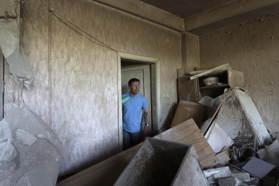 Vladimir Golubenko looks at his office damaged by a drone during a night attack in Kyiv, Ukraine, Sunday, May 28, 2023. Ukraine's capital was subjected to the largest drone attack since the start of Russia's war, local officials said, as Kyiv prepared to mark the anniversary of its founding on Sunday. (AP Photo/Vasilisa Stepanenko)