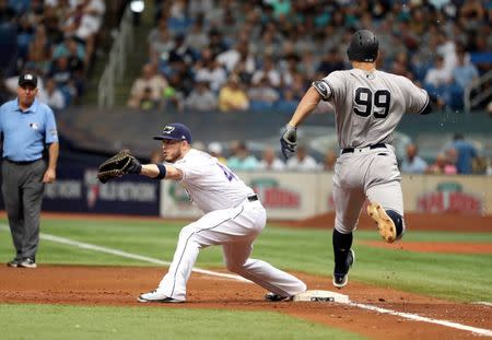 Jun 23, 2018; St. Petersburg, FL, USA; Tampa Bay Rays left baseman C.J. Cron (44) forces out New York Yankees right fielder Aaron Judge (99) during the second inning at Tropicana Field. Mandatory Credit: Kim Klement-USA TODAY Sports