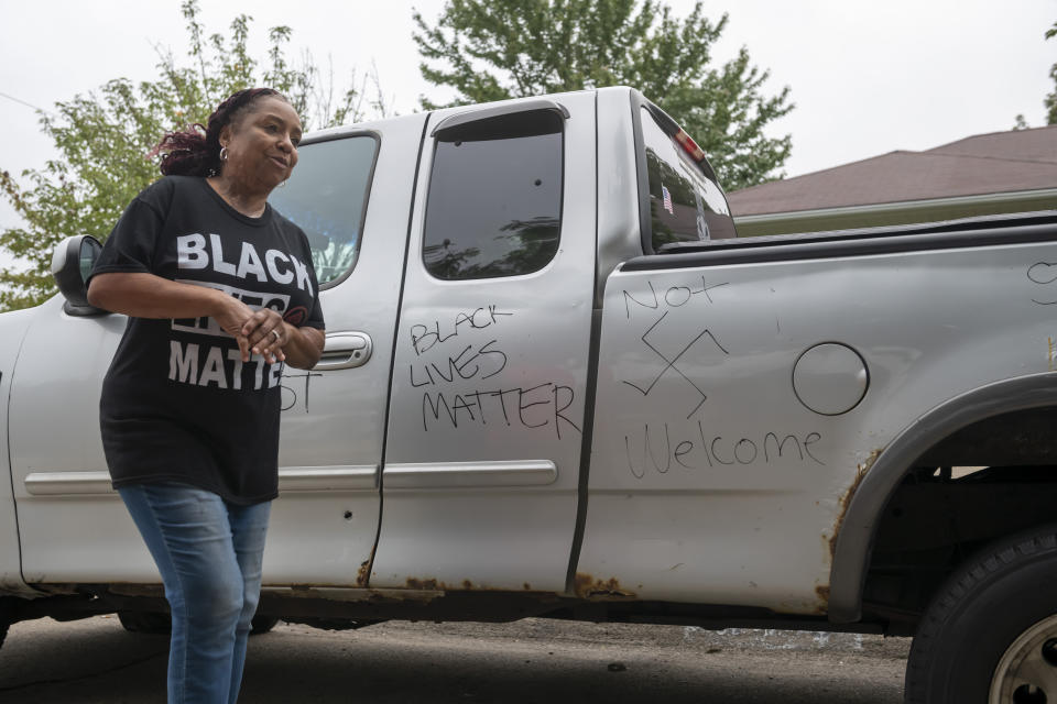 FILE - Candace Hall stands in front of graffiti written on her truck in front of her Warren, Mich., home on Thursday, Sept. 10, 2020. Some experts say political and social unrest as well as the coronavirus pandemic has taken a disproportionate physical and financial tolls on Black people, resulting in increased anxiety levels among African Americans. (David Guralnick/Detroit News via AP, File)