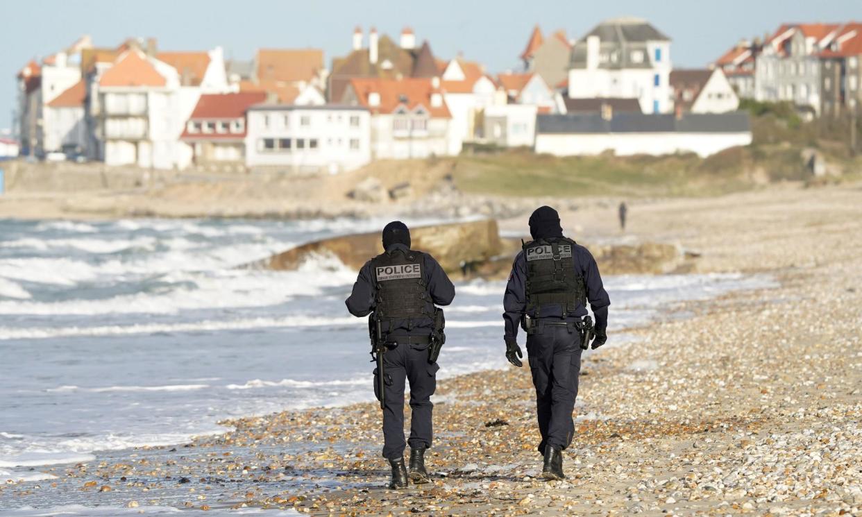 <span>French police officers patrol the beaches in Wimereux, from where the boat departed for the UK.</span><span>Photograph: Gareth Fuller/PA</span>