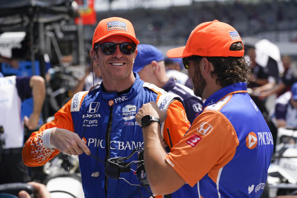 Scott Dixon, left, of New Zealand, talks with a crew member during practice for the Indianapolis 500 auto race at Indianapolis Motor Speedway, Tuesday, May 17, 2022, in Indianapolis. (AP Photo/Darron Cummings)