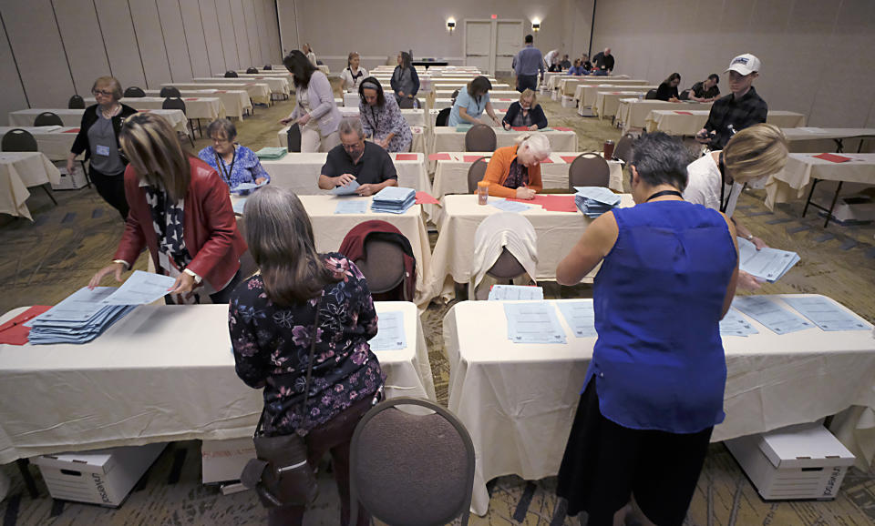 Tellers begin counting ballots for Virginia's Republican gubernatorial nominee race inside a ballroom at the Marriott Hotel in Richmond, Va., Monday, May 10, 2021. (Bob Brown/Richmond Times-Dispatch via AP)