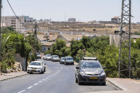 Beit El, the settlement that has entranced the Trump administration with security walls in the background (Bel Trew)