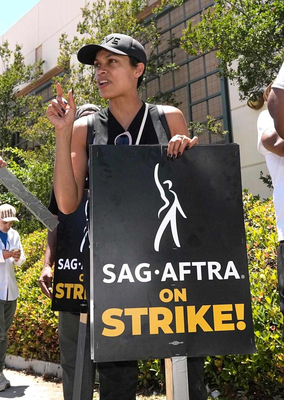 Actor Rosario Dawson attends a rally by striking writers and actors outside Warner Bros. studios in Burbank, Calif. on Friday, July 14, 2023. This marks the first day actors formally joined the picket lines, more than two months after screenwriters began striking in their bid to get better pay and working conditions and have clear guidelines around the use of AI in film and television productions.