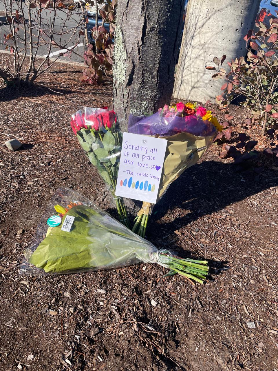 Flowers were left for the victims of a deadly crash at Derby Street Shops in Hingham Monday, Nov. 21, 2022.