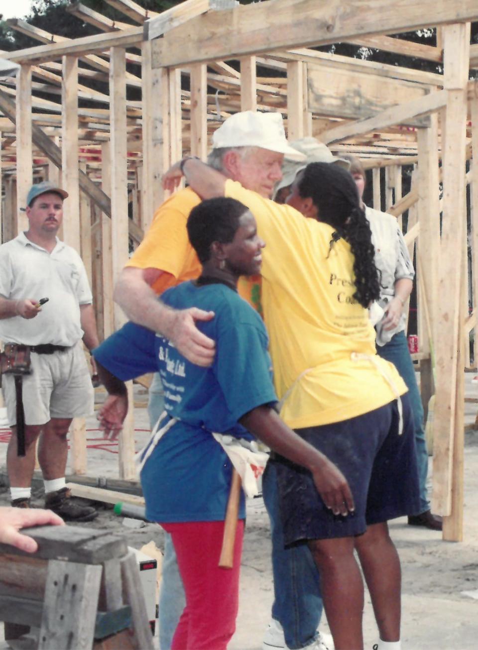 In 2000, former President Jimmy Carter greets Johnnie Williams and her family members, who would be living in the HabiJax home Carter was helping to build.