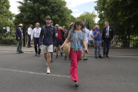 Spectators walk to the courts after clearing the security check on day one of the Wimbledon tennis championships in London, Monday, June 27, 2022. (AP Photo/Alastair Grant)