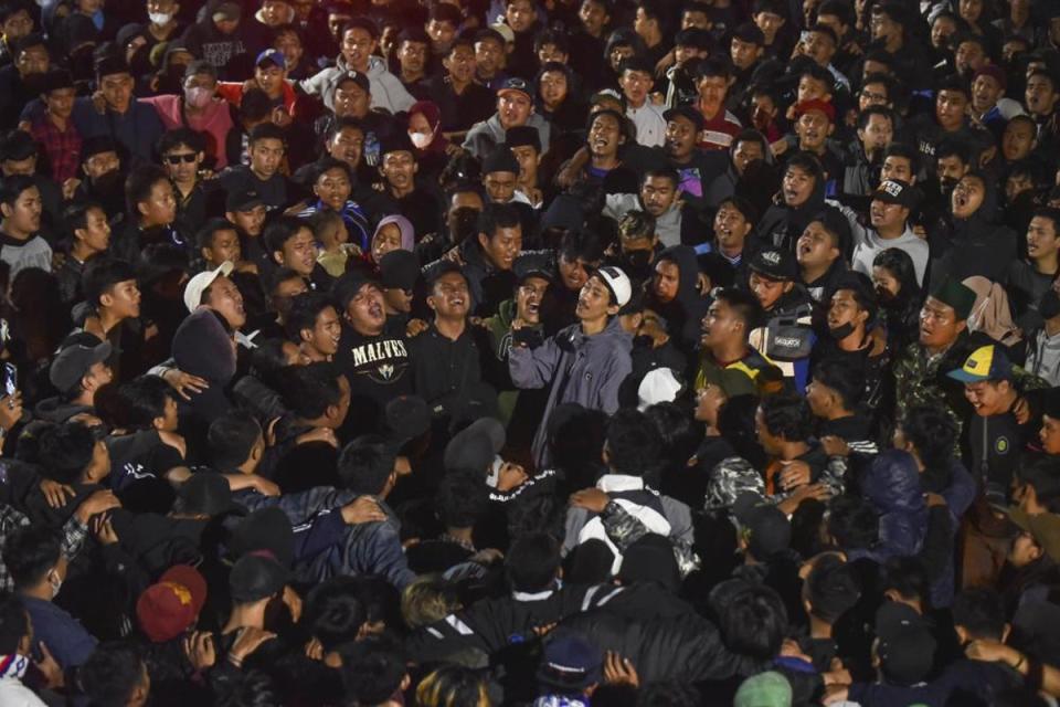 Soccer fans chant slogans during vigil for the victims of Saturday’s deadly crush, in Malang, East Java, Indonesia. (AP)