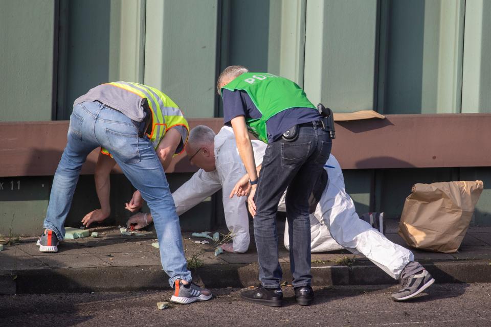 Police officers and forensic experts secure evidences at the site where a motorcycle crashed with a car, probably the car used by an alleged offender to cause several accidents on the A 100 highway in Berlin on August 19, 2020. - A man caused a series of motorway accidents in Berlin on Tuesday night, injuring six people including three seriously in what German prosecutors have described as an Islamist act. (Photo by Odd ANDERSEN / AFP) (Photo by ODD ANDERSEN/AFP via Getty Images)