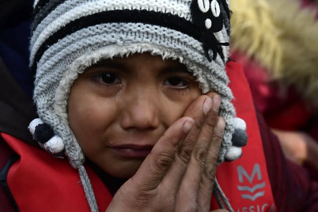 A refugee child cries as he arrives at the village of Skala Sikaminias, on the Greek island of Lesbos