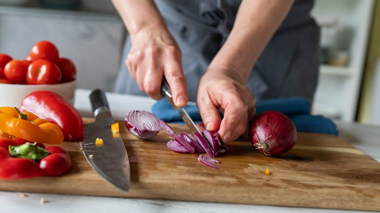 person chopping red onions