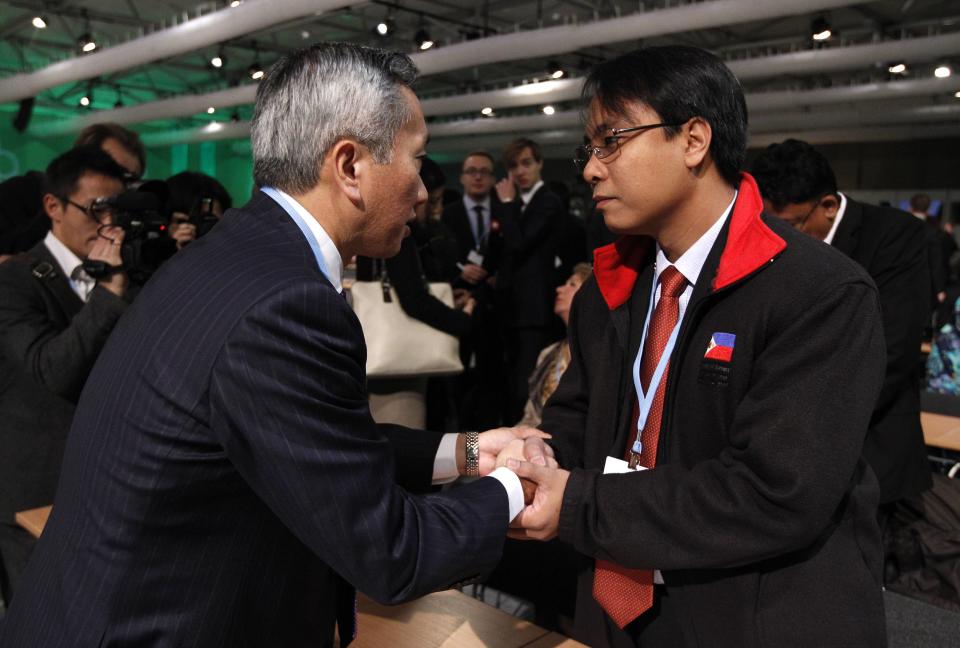 Japanese representative Minami expresses his sympathy to Philippine representative Sano at COP19 in Warsaw