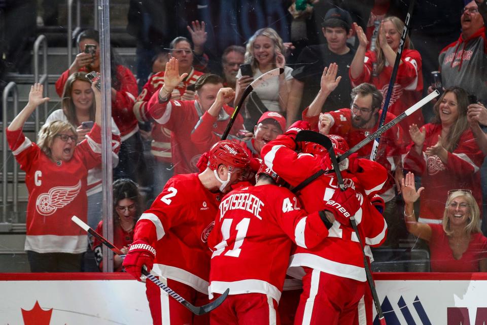 Detroit Red Wings players celebrate a goal scored by right wing Alex DeBrincat (93) against Montreal Canadiens during the third period at Little Caesars Arena in Detroit on Monday, April 15, 2024.