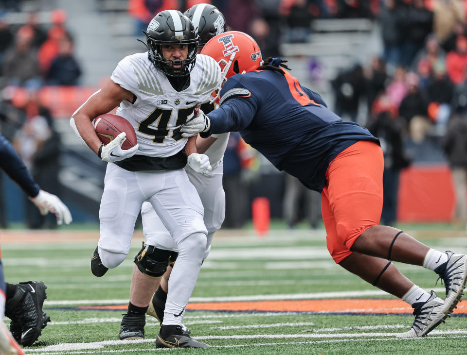 CHAMPAIGN, IL – NOVEMBER 12: Devin Mockobee #45 of the Purdue Boilermakers runs the ball against Jer’Zhan Newton #4 of the Illinois Fighting Illini during the first half at Memorial Stadium on November 12, 2022 in Champaign, Illinois. (Photo by Michael Hickey/Getty Images)