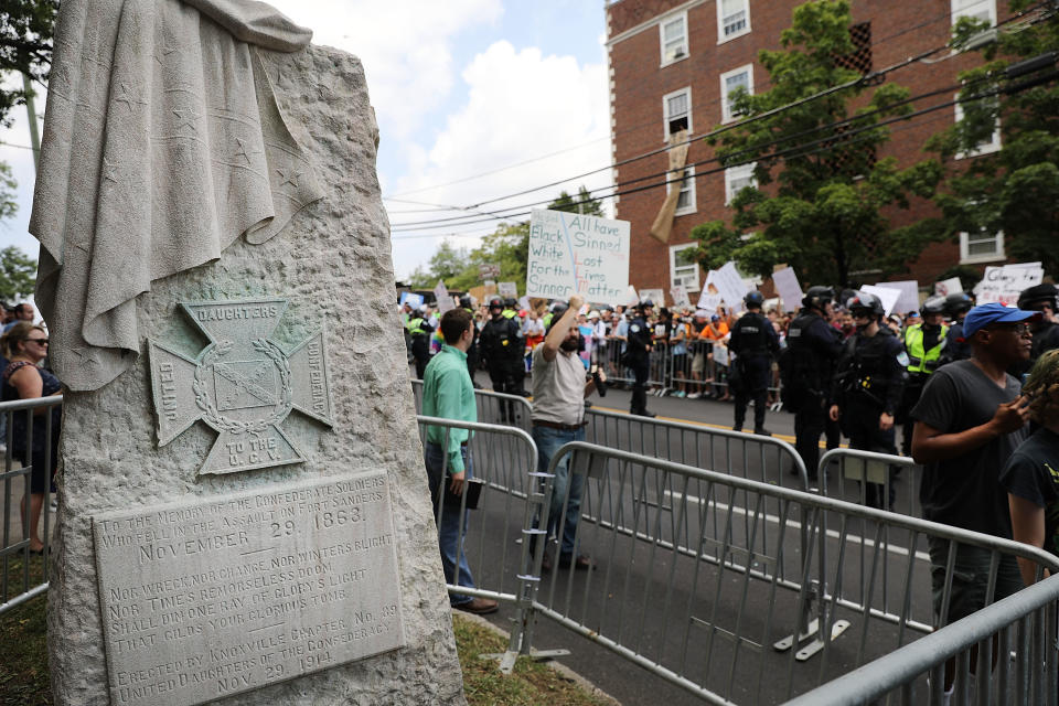 <p>Hundreds of protesters demonstrate against a Confederate monument in Fort Sanders as a smaller number of pro-confederate supporters stand against the removal of the memorial monument on Aug. 26, 2017 in Knoxville, Tenn. (Photo: Spencer Platt/Getty Images) </p>