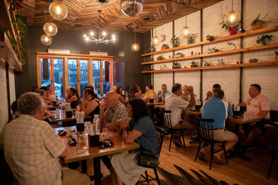 People try the food at Ima in Corktown as part of the EAT Detroit restaurant experience in Detroit on August 3, 2022. People tried 23 different restaurants throughout downtown area as part of the event.