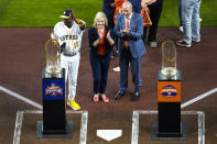 Houston Astros manager Dusty Baker Jr. (12) waves as he, team owner Jim Crane and his wife, Whitney, stand with the Astros' two World Series trophies before the baseball team's season opener against the Chicago White Sox on Thursday, March 30, 2023, in Houston. (Brett Coomer/Houston Chronicle via AP)