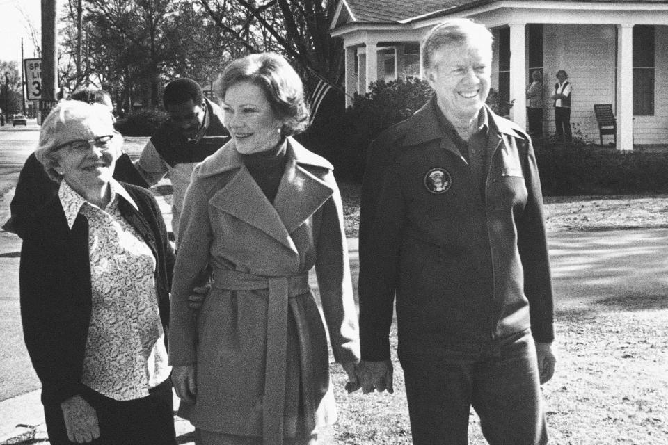 FILE - Former President Jimmy Carter, wife Rosalynn, and mother-in-law Allie Smith walk through Plains, Ga., Jan. 23, 1981, back home from their office. The new office for the Carter's is the former home of his mother, Lillian Carter. The mishandling of classified documents is not a problem unique to President Joe Biden and former President Donald Trump. At least three presidents, including Carter, a vice president, a secretary of state and an attorney general have all been tripped up. (AP Photo/Wayne Perkins, File)