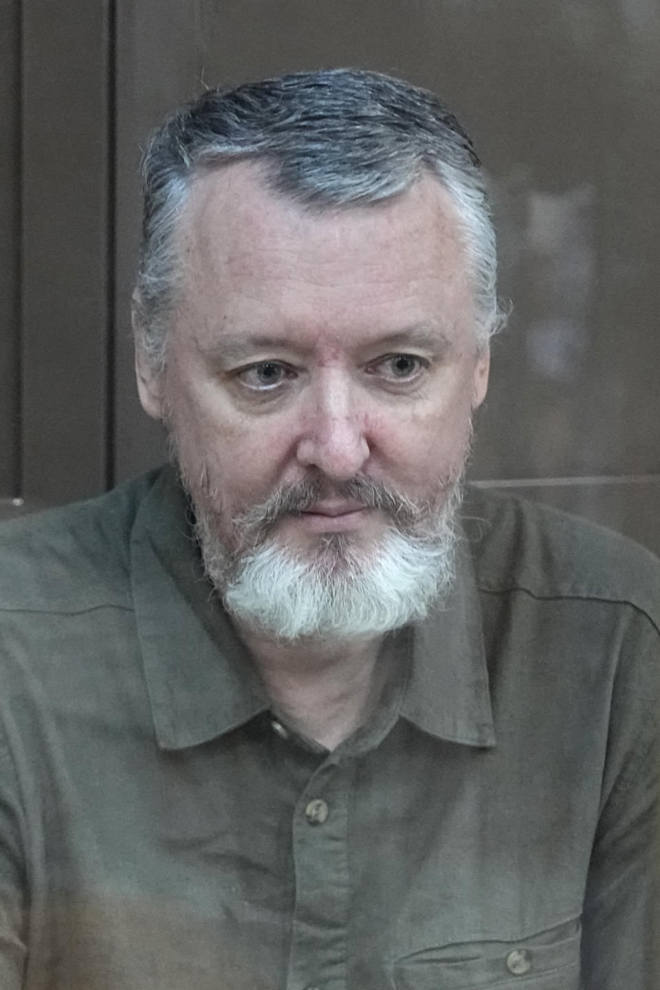 Igor Girkin also know as Igor Strelkov, the former military chief for Russia-backed separatists in eastern Ukraine, sits in a glass cage in a courtroom at the Moscow's City Court in Moscow, Russia, on Tuesday, Aug. 29, 2023. A prominent Russian hard-line nationalist who accused President Vladimir Putin of weakness and indecision in Ukraine was detained on charges of extremism. (AP Photo/Alexander Zemlianichenko)