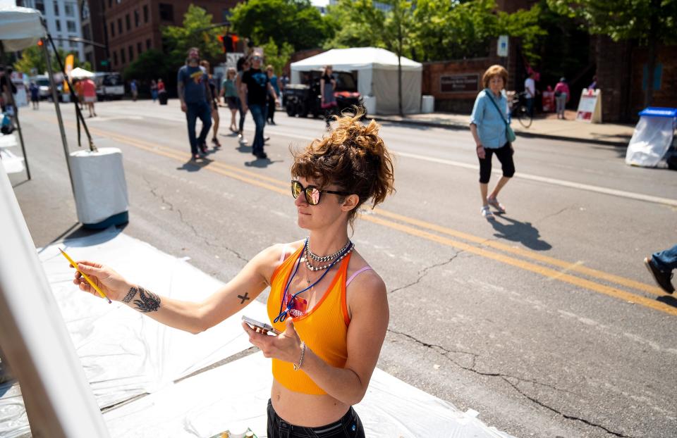 Bridgette Barnes works on her piece as part of the Scribble event at the Columbus Arts Festival in downtown Columbus in 2023. The festival is working with Accessible Ohio to make the event open and accessible to more people.