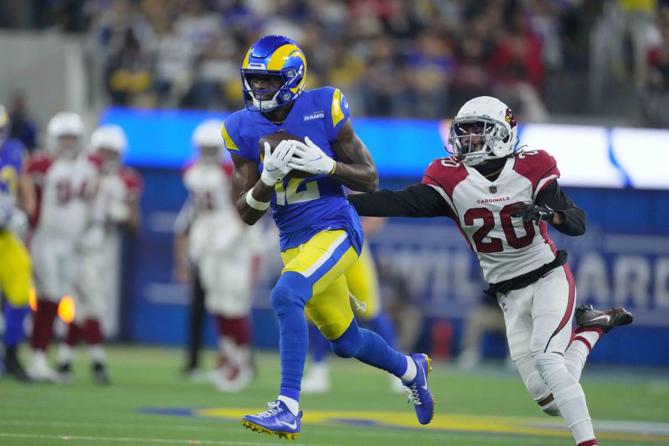 Jan 17, 2022; Inglewood, California, USA; Los Angeles Rams wide receiver Van Jefferson (12) catches a pass as Arizona Cardinals cornerback Marco Wilson (20) defends during the second half of an NFC Wild Card playoff football game at SoFi Stadium. The Rams defeated the Cardinals 34-11. Mandatory Credit: Kirby Lee-USA TODAY Sports