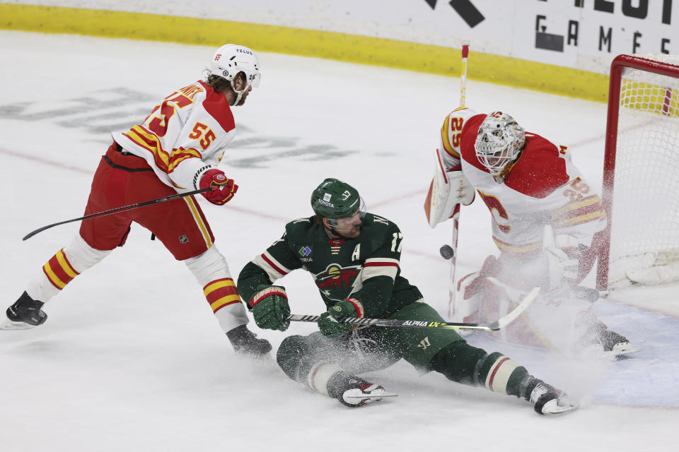 Minnesota Wild left wing Marcus Foligno (17) tries to score against Calgary Flames goaltender Jacob Markstrom (25) during the first period of an NHL hockey game Tuesday, March 7, 2023, in St. Paul, Minn. (AP Photo/Stacy Bengs)