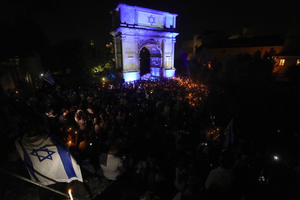 FILE - People attend a torchlit during a rally in support of Israel, at the Emperor Tito's Arch in Rome, on Oct. 10, 2023. Antisemitism is spiking across Europe after Hamas' Oct. 7 massacre and Israel's bombardment of Gaza, worrying Jews from London to Geneva and Berlin. (AP Photo/Andrew Medichini, File)
