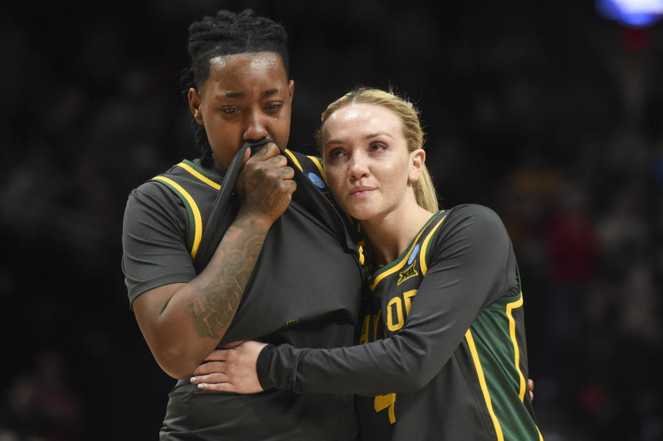 Baylor guard Jana Van Gytenbeek (4) comforts Baylor forward Dre'Una Edwards, left, after a Sweet 16 college basketball game against Southern California in the NCAA Tournament, Saturday, March 30, 2024, in Portland, Ore. Southern California won 74-70. (AP Photo/Steve Dykes)