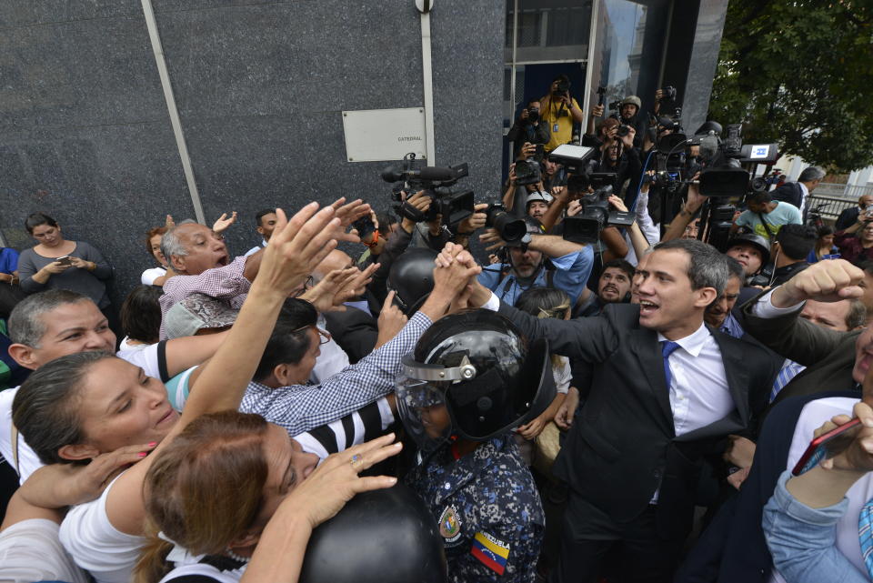 Opposition leader Juan Guaido greets supporters as he leaves the National Assembly in Caracas, Venezuela, Tuesday, Jan. 7, 2020. Venezuela’s opposition is facing its biggest test yet after government-backed lawmakers announced they were taking control of what Guaidó supporters have described as the nation’s last democratic institution. (AP Photo/Matias Delacroix)