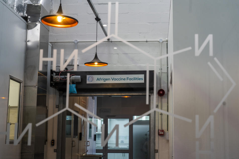 A sign hangs at an Afrigen Biologics and Vaccines facility in Cape Town, South Africa, Tuesday, Oct. 19, 2021. A team of Afrigen scientists is assembling the equipment needed to reverse engineer Moderna's coronavirus vaccine. The scientists are effectively making an end run around an industry that has vastly prioritized rich countries over poor in both vaccine sales and manufacturing. ​(AP Photo/Jerome Delay)