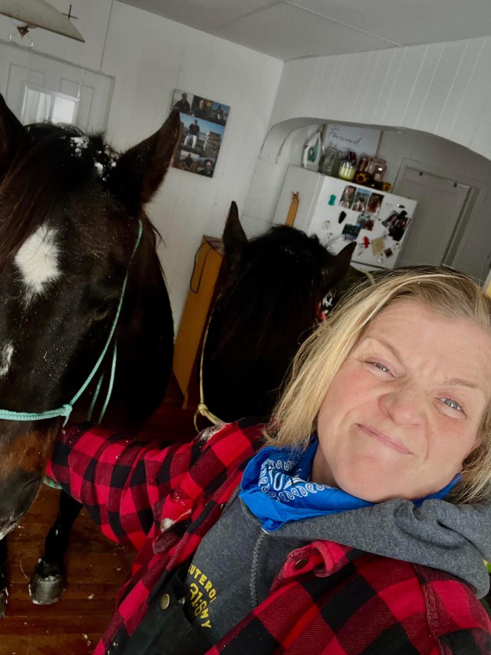 Kelly Rowley with Rip and Diamond as they warm up in her dining room.