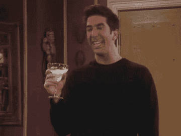 Ross from "Friends" holding a cocktail.