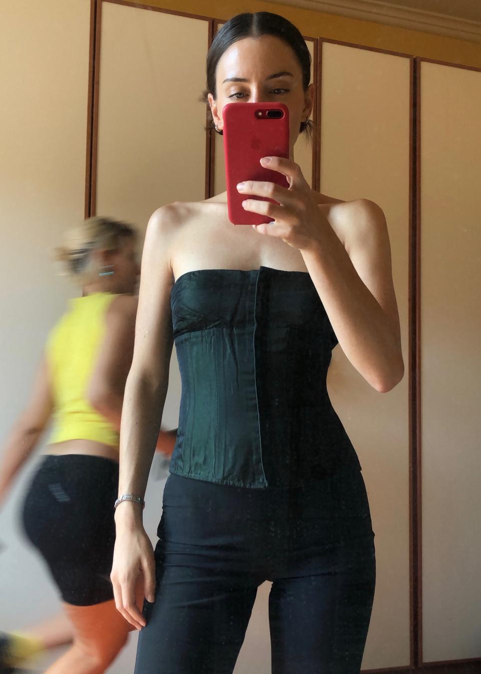 La Roche in a deadstock corset by an Italian designer and Prada pants.