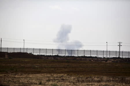 Smoke from a strike rises in Egypt's North Sinai as seen from across the border in southern Israel July 2, 2015. REUTERS/Amir Cohen