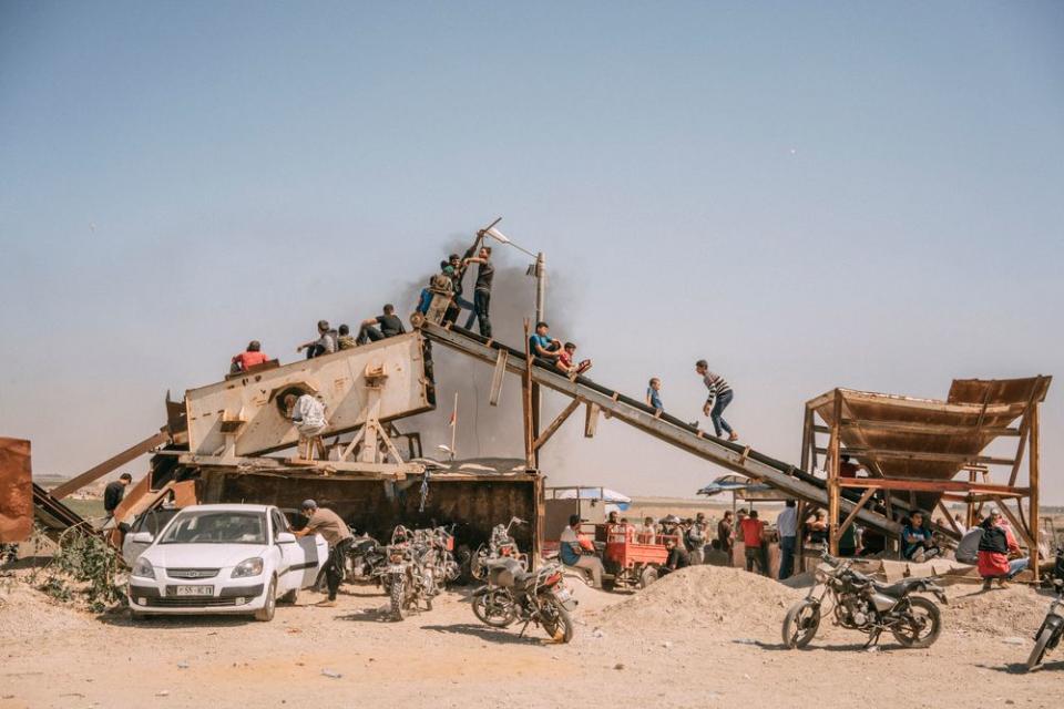 Palestinian boys observe the protest along the Gaza-Israel border.