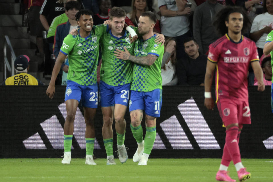 Seattle Sounders' Léo Chú (23), Reed Baker-Whiting (21) and Albert Rusnák (11) celebrate a goal against St. Louis City SC during the first half of an MLS soccer match on Saturday, Oct. 21, 2023, in St. Louis. (Laurie Skrivan/St. Louis Post-Dispatch via AP)