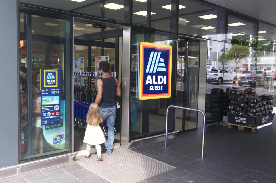 Lugano, Ticino, Switzerland - 19th August 2019 : People entering a Aldi supermarket shop in Switzerland. ALDI is a german company and one of the biggest discount supermarket chains in the world