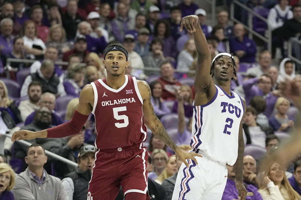 Oklahoma guard Rivaldo Soares (5) looks on as TCU forward Emanuel Miller (2) scores a basket during the second half of an NCAA college basketball game in Fort Worth, Texas, Wednesday, Jan. 10, 2024. (AP Photo/LM Otero)