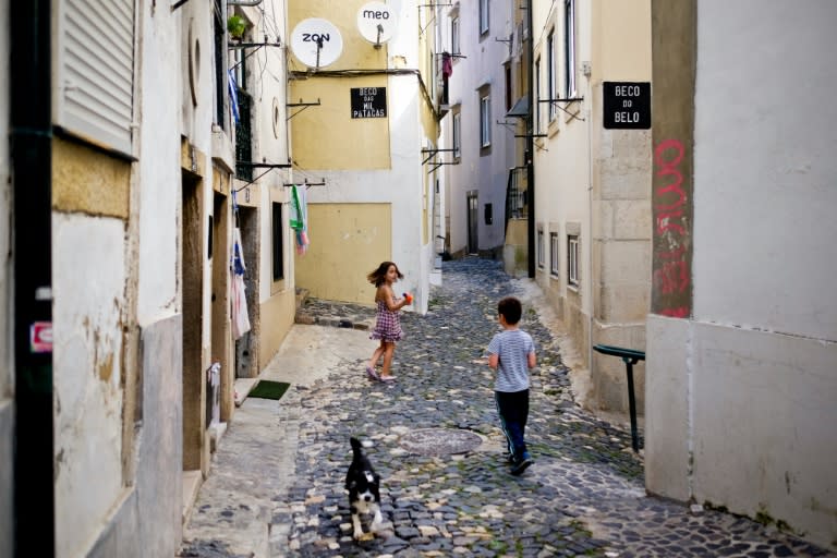 Kids play in the streets of Alfama neighborhood in Lisbon, which is seeing residents pushed out to make way for short-term tourist leases