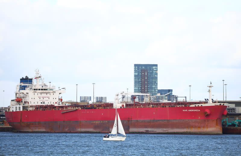 A sailboat passes in front of the Liberia-flagged oil tanker Nave Andromeda at Southampton Docks, following a security incident aboard the ship the night before off the coast of Isle of Wight, in Southampton