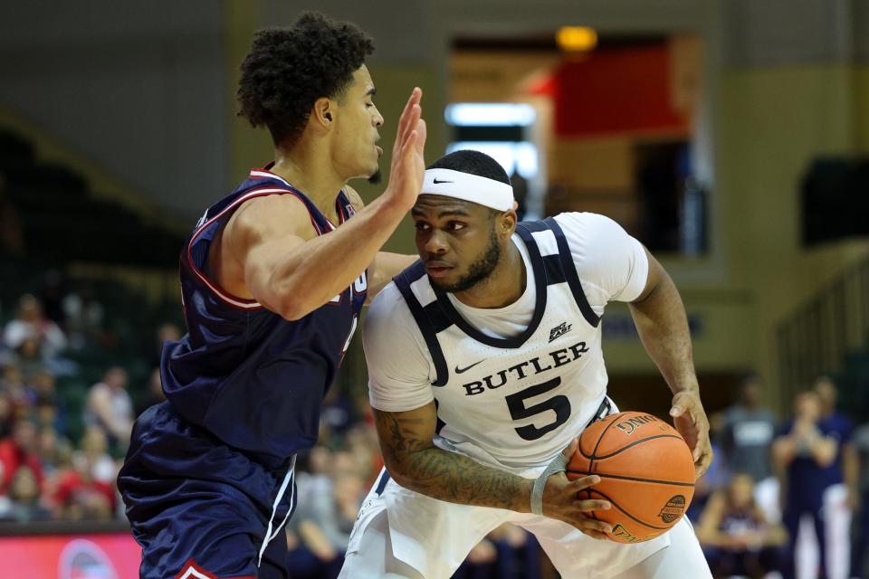 Nov 23, 2023; Kissimmee, Florida, USA; Butler Bulldogs guard Posh Alexander (5) is guarded by Florida Atlantic Owls guard Bryan Greenlee (4) in the second half during the ESPN Events Invitational at State Farm Field House.