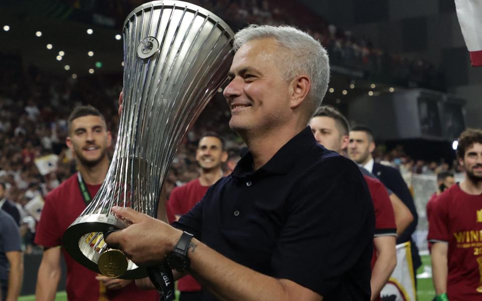 Roma's Portuguese head coach Jose Mourinho with the trophy after winning the UEFA Europa Conference League - AFP